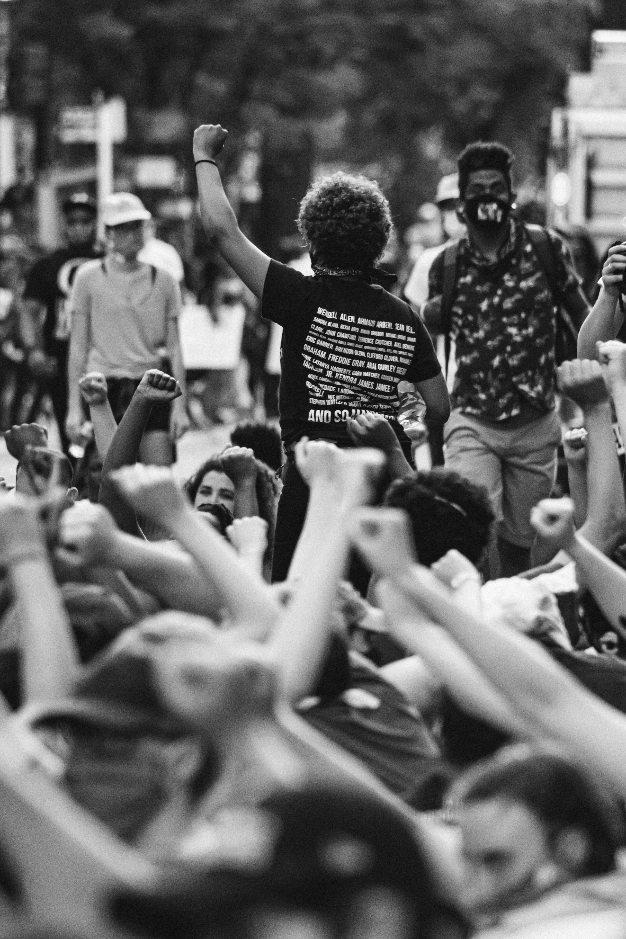 Rally with engaged protestors raising fists in resistance