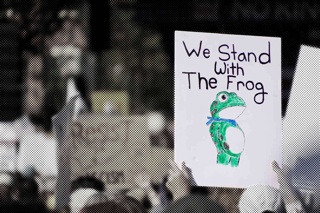 Volunteer holding protest sign